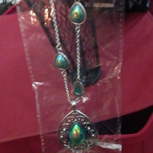 Paparazzi blue iridescent teardrop stones necklace with matching earrings.